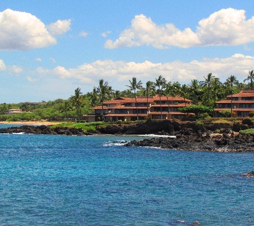 Red roofed low-rise condominiums along the South Maui shoreline